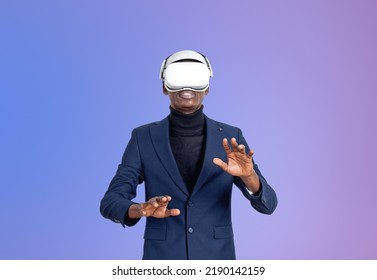 African Businessman Wearing Vr Glasses Headset, Fingers Touching Something On Purple Gradient. Concept Of Metaverse And Futuristic Technology. Copy Space