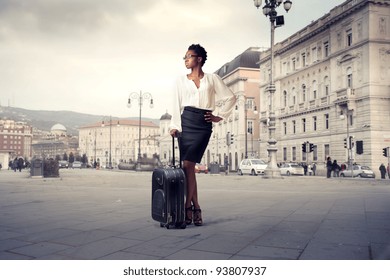 African Businesswoman Holding A Trolley Case On A City Square