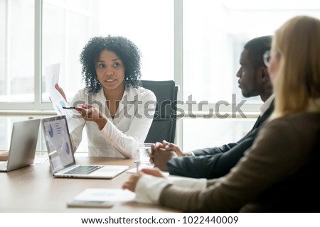 African businesswoman showing good statistics report explaining deal advantages convincing multiracial partners at negotiations meeting, black manager consulting diverse clients promising benefits