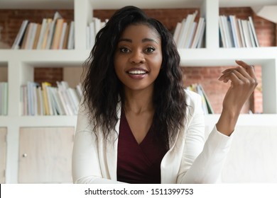 African Businesswoman Sit Indoors Looks At Camera Talking With Corporate Client Discuss Common Business Use Virtual Communication Make Video Call, Skilled Coach Helps To Apprentice Distantly Concept