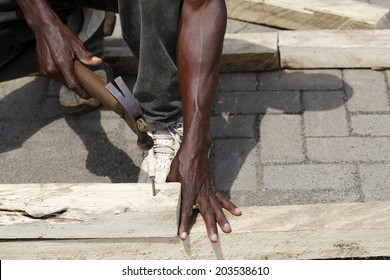 African Carpenter Works With Wood