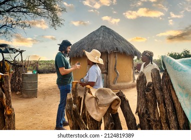 African and Caucasian people in an African village