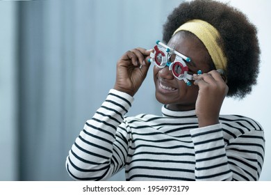 African Child Girl Checking Vision With Eye Test Glasses During Optic Test, Optical Equipment For Examine The Vision