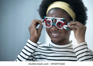 African Child Girl Checking Vision With Eye Test Glasses During Optic Test, Optical Equipment For Examine The Vision