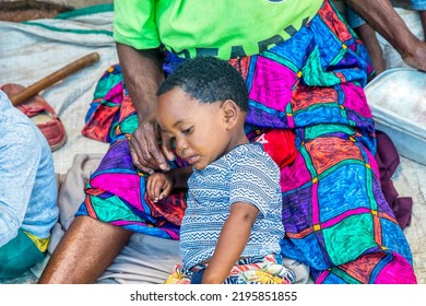 African Child Siting In His Granny Lap In The Yard