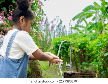 African Child Washing Hands. Child Washing Hands And Showing Soapy Palms. Health Care And Kid Concept. Washing Her Hands Before Eating Food And After Play The Toys At The Washing Bowl.