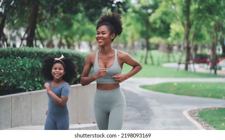 African children and families happily play outdoor sports in the garden.Man jogging with nature in the garden.On summer vacation, the family happily took a walk in nature. - Powered by Shutterstock