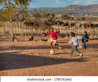 African Children Playing Soccer On The Dirt In His Yard In A Village In Botswana