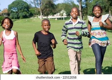 African Children Running In The Park Towards Camera