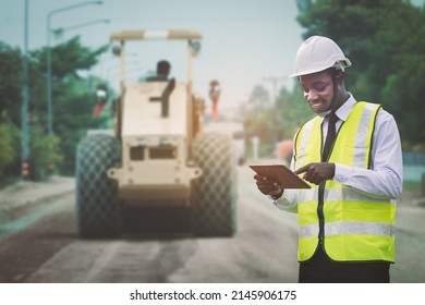 African civil engineering working with use tablet for control the road rebuilding and inspect the construction site