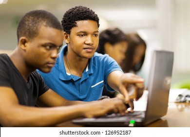 african college students using laptop together