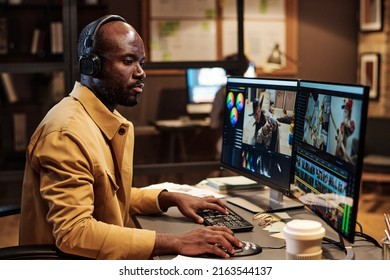 African colorist concentrating on his work at office till late evening, he editing footage on computer - Shutterstock ID 2163544137