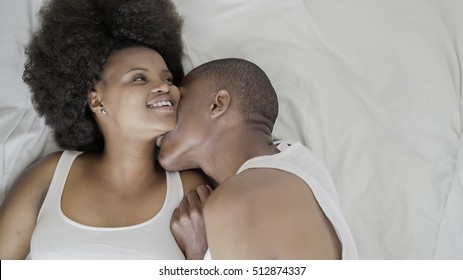 African couple in bed - Powered by Shutterstock