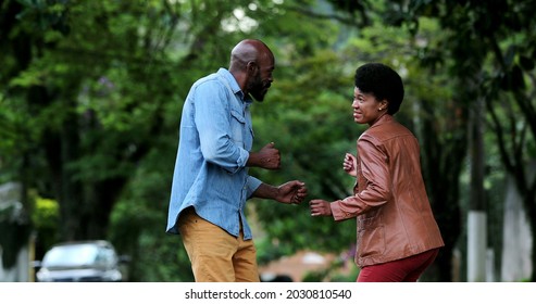 African Couple Dancing Outside In Street