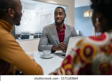 African Couple Meeting With Black Male Financial Adviser bank manager Relationship Counselor In Office