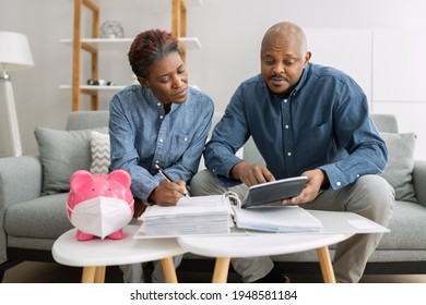 African Couple Saving Money And Doing Budget