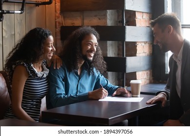 African couple sign contract buy services insurance after negotiations in cafe with company broker. Buy home, first flat ownership, put signature on document approve terms conditions make deal concept