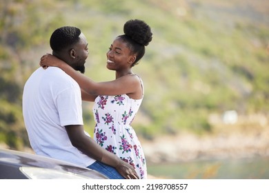 African Couple With Smile On Road Trip With Car, Travel On Summer Vacation And Happy On Drive With Transport. Happiness, Smile And Love Man And Woman Giving Hug At The Sea During A Date In Spring