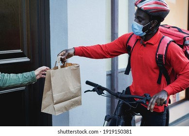 African Courier Man Delivering Meal With Electric Bike - Focus On Face