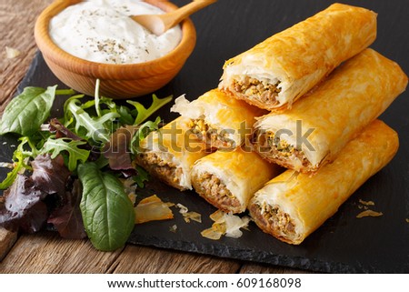 African cuisine: rolls stuffed with minced meat and eggs close-up on the table. horizontal
