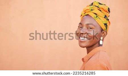 African, culture and portrait of happy black woman with pride in unique tradition, origin and South Africa heritage. Fashion mock up, head wrap and face of beauty girl isolated on mockup orange wall