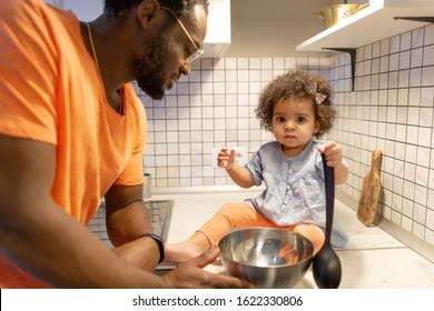 African Dad With A Little Daughter Standing In The Kitchen Preparing To Eat For Mom. Day Off For Mom