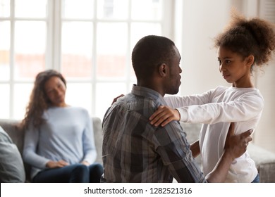 African Dad Talking To Daughter Supporting Or Explaining Little Mixed Race Girl During Friendly Conversation At Home, Black Father Speaking To Child Having Good Trustful Relationships With Kid