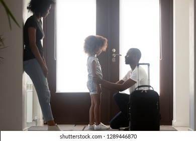 African Dad Talking To Upset Mixed Race Kid Daughter Leaving Family With Suitcase In Hallway, Black Father Saying Goodbye To Sad Little Girl, Child Of Divorced Parents And Shared Custody Concept