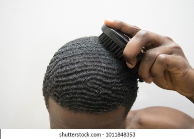 African Dark Skin Man Brushing Black Wavy Hair