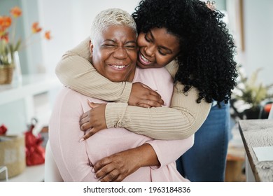 African Daughter Hugging Her Mum Indoors At Home - Main Focus On Senior Woman Face