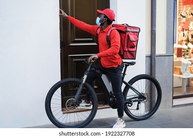 African Delivery Man With Electric Bike Ringing The Doorbell - Focus On Face