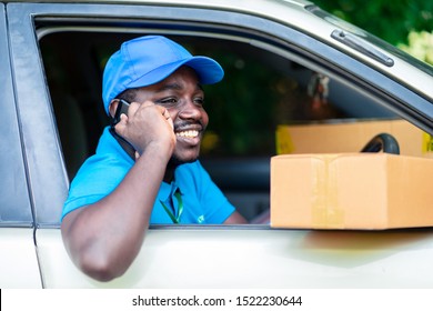 African Delivery Man Talking By Phone In The Car