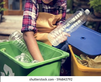 African Descent Kid Separating Recyclable Trash - Powered by Shutterstock