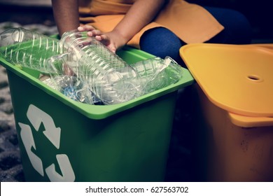 African Descent Kid Separating Recyclable Trash - Powered by Shutterstock