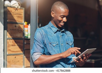 African Designer And Small Business Owner With Tablet In Studio