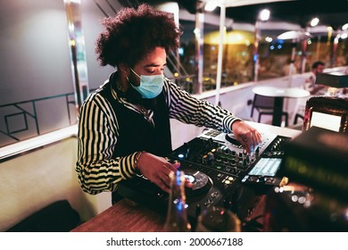 African Dj Playing Music At Cocktail Bar Outdoor While Wearing Face Safety Mask - Soft Focus On Right Hand