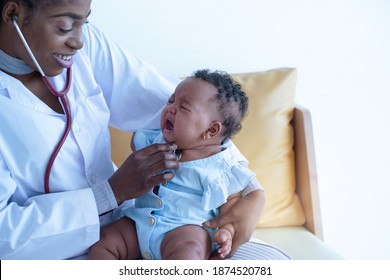 African Doctor Checking Mix Race Newborn Baby, Pediatrician Examining Baby Girl With Stethoscope