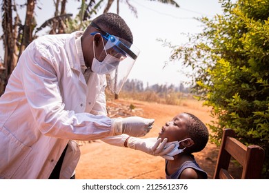 An african doctor does a swab test on a child to see if he positive to coronavirus. Covid-19 test in Africa. Molecular and rapid antigen test - Powered by Shutterstock