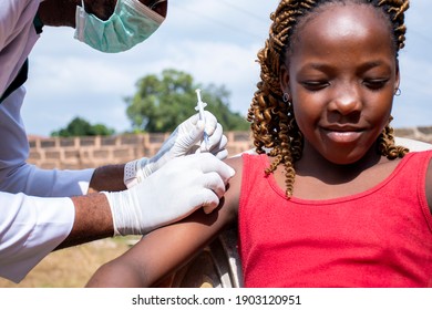 African Doctor Offering Vaccine To A Young Beautiful Girl On Her Arm Due To The Pandemic