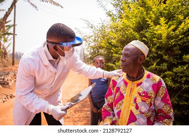 African Doctor Visits An Elderly Patient And They Converse During The Medical Examination. Health Care In Africa Concept