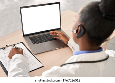 African Doctor Wear Headset Consult Female Black Patient Make Online Webcam Video Call On Laptop Screen. Telemedicine Videoconference Remote Computer App Virtual Meeting. Over Shoulder Videocall View.