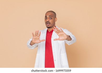 African Doctor Wearing A Lab Coat On A Yellow Background