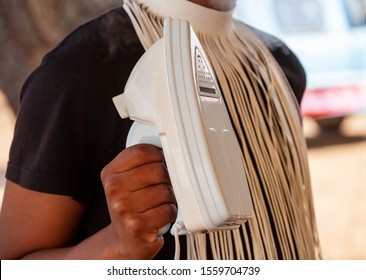 African Domestic Worker Holding A Steaming Iron