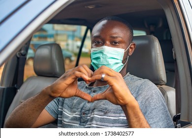 African Driver Wearing A Face Mask, Doing The Heart Shape With His Hands