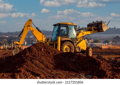 African driver working on an earthmoving machine in South Africa