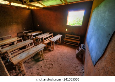 African Elementary School Classroom In A Clay Building With Dirt Floors.