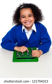 African Elementary School Kid Using Big Green Calculator. Education And Technology.