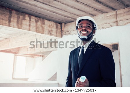 African engineer man architect looking at construction project