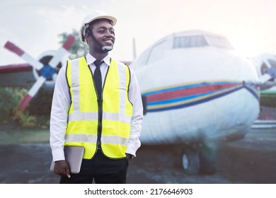 African Engineer Man, Technician Checking And Fixing Aircraft Engine With Tablet In Hand