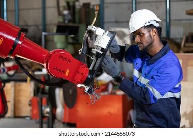 African Engineer Or Worker Checking And Fixing Machine In Robot Factory